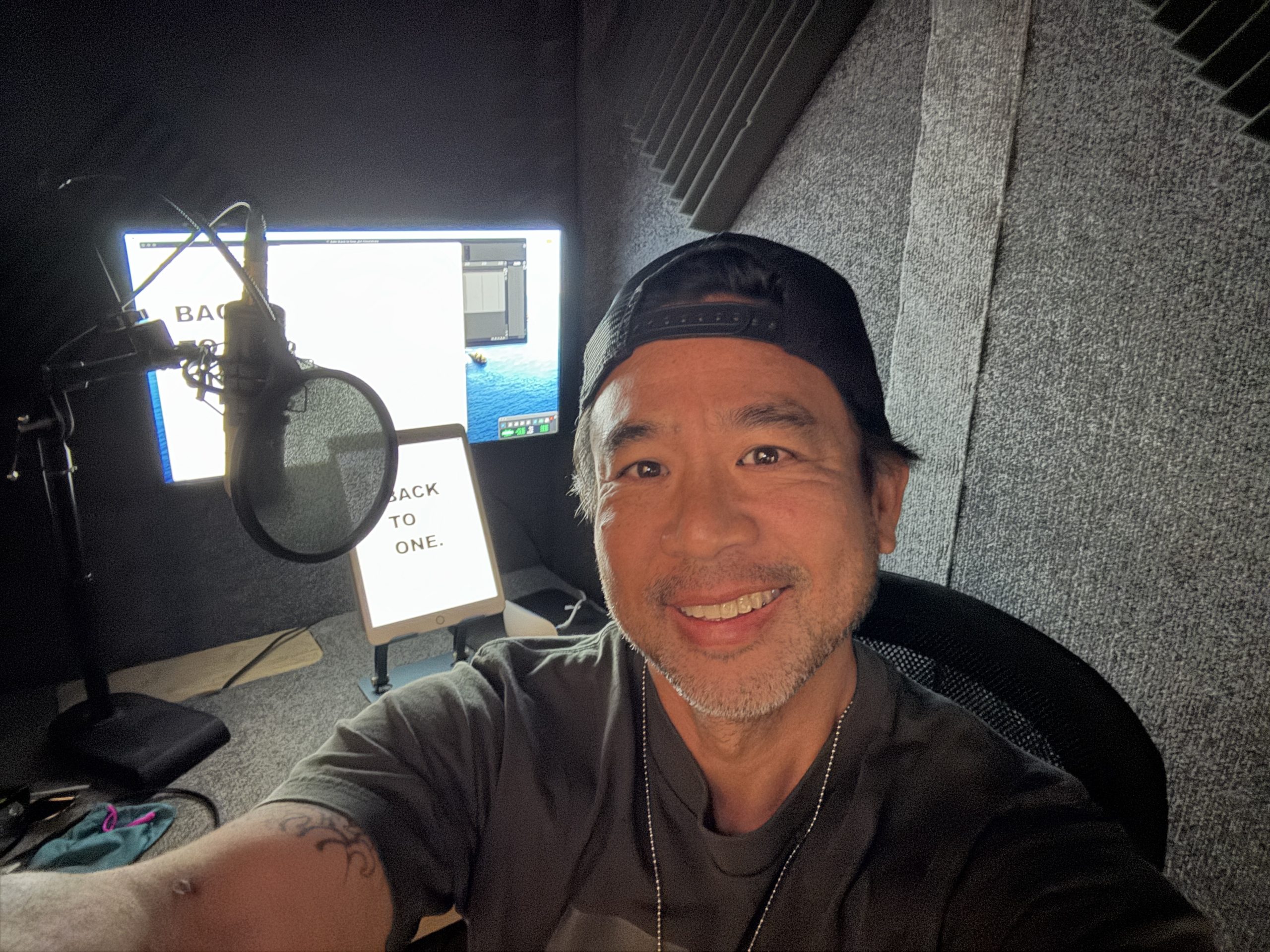 Art Chudabala at the microphone recording the audiobook for Back to One